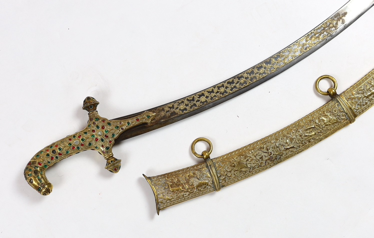 A fine Indian gilt copper and paste mounted sword (shamshir), Kutch, 19th century, sword 79cm long, scabbard 75cm long